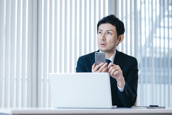 男性がメールを送ろうとしているイメージ